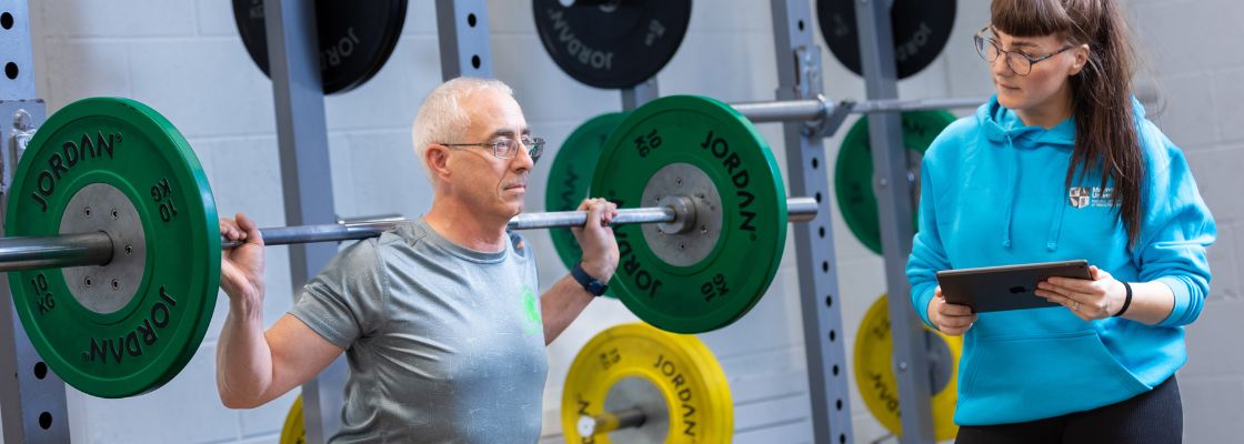 older man lifting weights