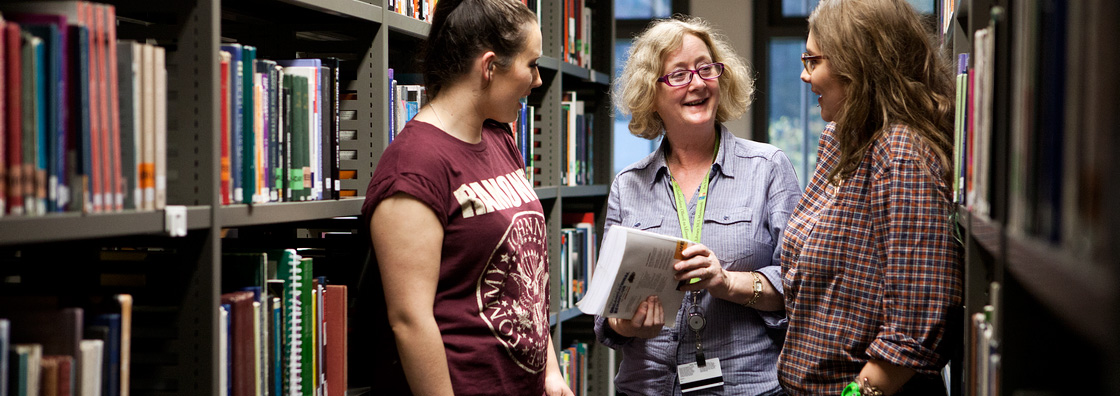 Library Assistant chats to students - Maynooth University