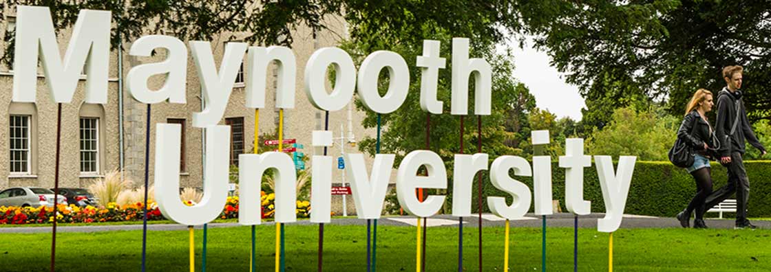 Communications - Little flower sign with people walking - Maynooth University