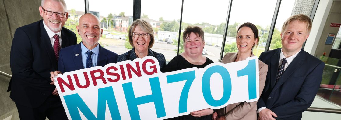 Maynooth University staff stand behind a sign reading 'Nursing MH701"