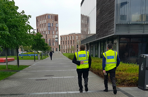 two security guards walking on campus