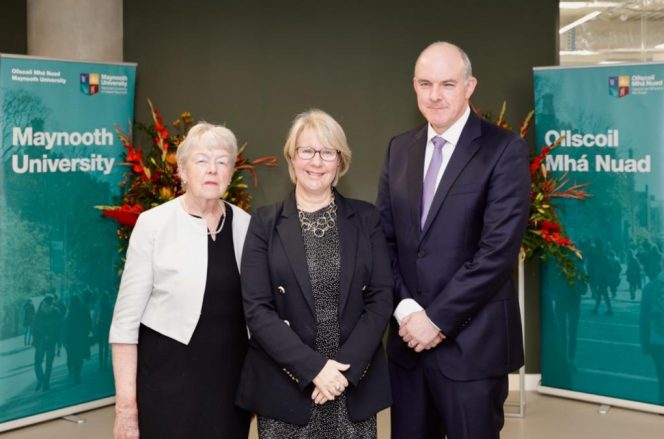 three people, 2 women and 1 man, pictured smiling and looking at the camera