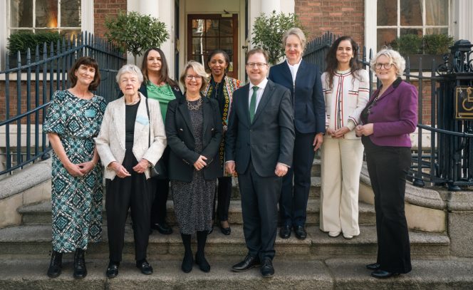8 women and 1 man posing for picture outside Royal Irish Academy for International Women's Da