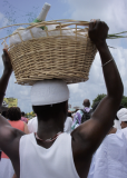 Image of man holding a wicker basket on his head