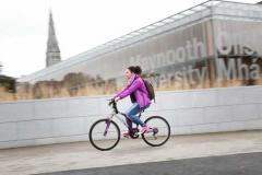 Communications & Marketing - Library sign bike female cyclist - Maynooth University