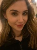 White Female with brown hair looking at the camera