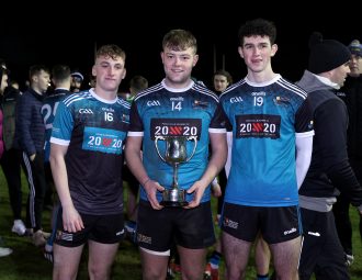 3 MUGAA fresher football players holding trophy