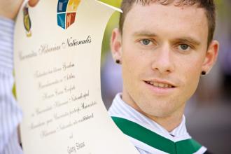 Graduation 2012 - male with scroll - Maynooth University