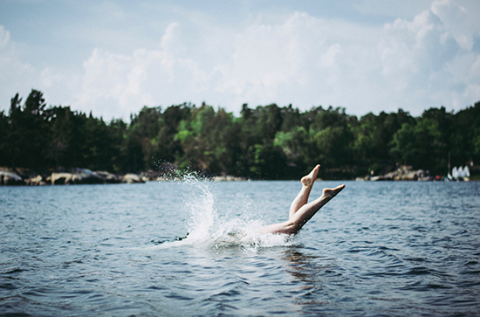 A person diving into a lake