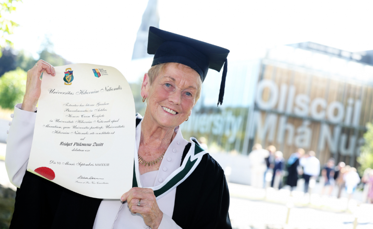 86-year-old lifelong learner Phil Devitt with BA degree certificiate