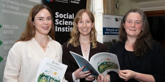 Image of three caucasian women holding a copy of the The Environment, Human Rights and the Windsor Framework report.