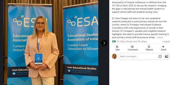Dr Clare Finegan stands in front of a blue ESAI banner at the ESAI Conference in Athlone, April 2025