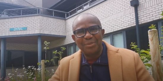 Image of Eze Ejikeme seated in a garden area on Maynooth University campus