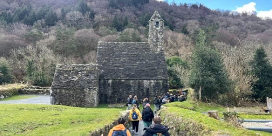 Monastic building at Glendalough with Irish Cultural Heritage students in foreground