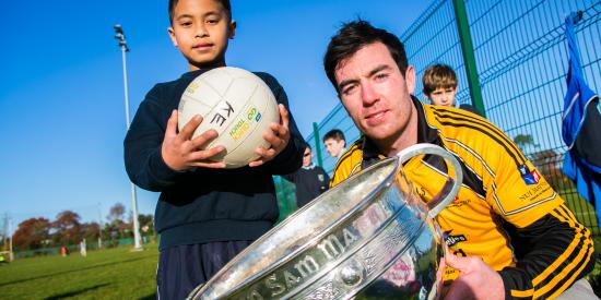 Student Union's meet your GAA heroes day - Michael Darragh MacAuley with a young pupil and the Sam Maguire Trophy