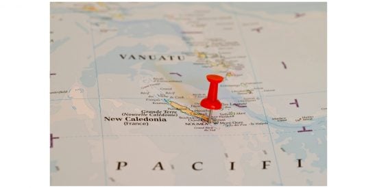 Map of Pacific showing island of New Caledonia with a red pin in it