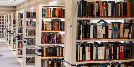 Row of shelves in a library filled with books