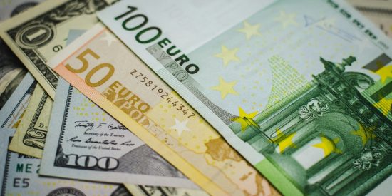 €100 note sitting on top of €50 note which are both on top of various US notes including $100 and $1