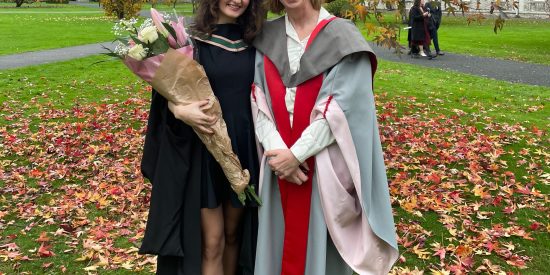 A photo of ygun Ipek and Pauline Garvey at the graduation ceremony