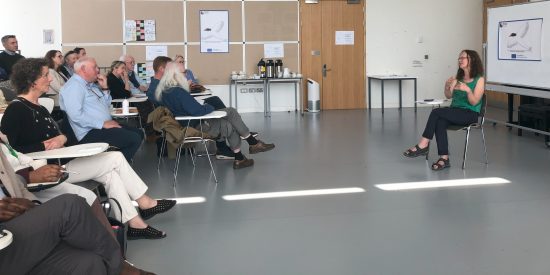 Seed Launch: Picture of SEED launch, group sitting in room with Dr Bernie Grummell giving presentation