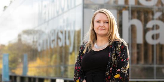 Shirley Howe stands in front of Maynooth University Library