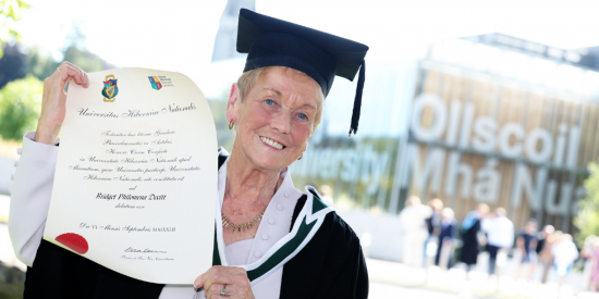 86-year-old lifelong learner Phil Devitt with BA degree certificiate
