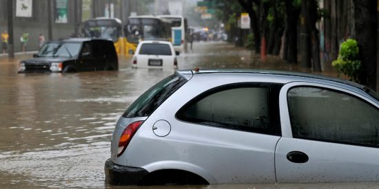 Silver car surrounded by flood waters