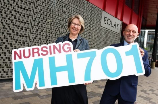 Man and woman holding a sign that reads 'Nursing, MH701'