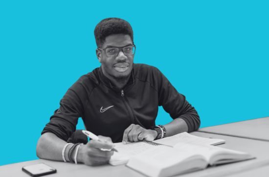 Student studying, light blue background.