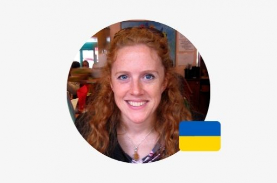 A portrait image of Claire Daly with a small Ukrainian flag icon
