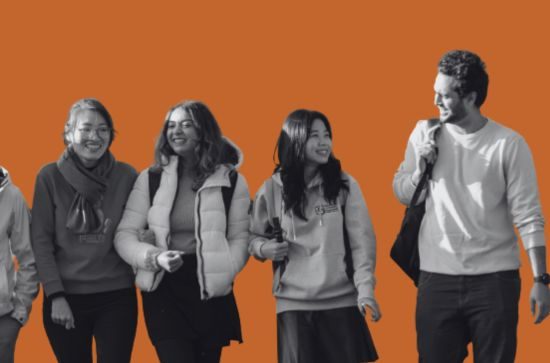 Students walking and talking together, orange background.