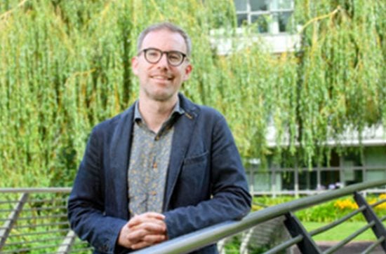 donal hassett standing on a bridge